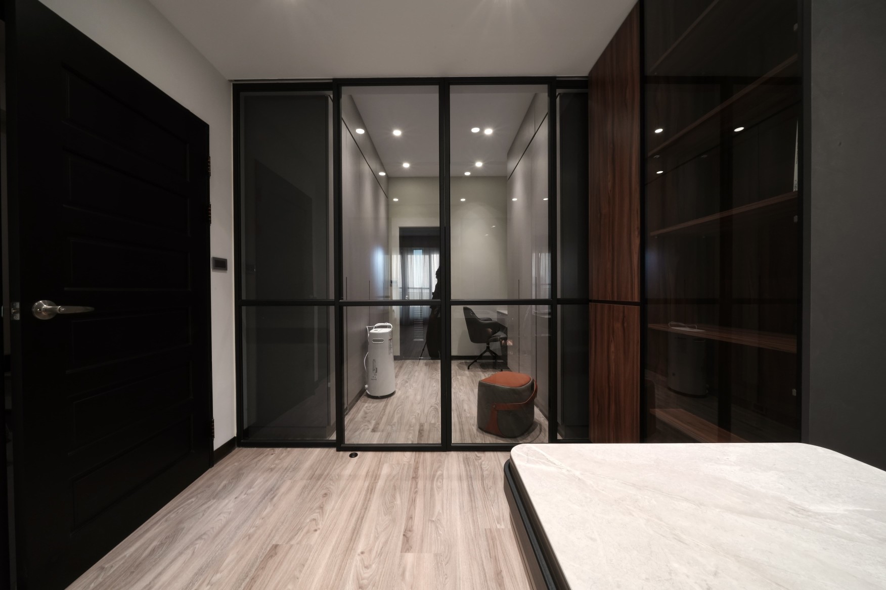 使用與一樓客廳及餐廳相同方式，以黑鐵框玻璃門作為空間的劃分，亦保有隱私。